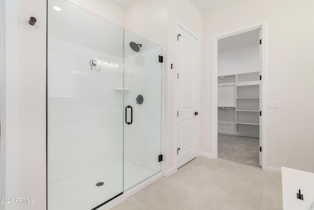 bathroom featuring an enclosed shower and tile patterned floors