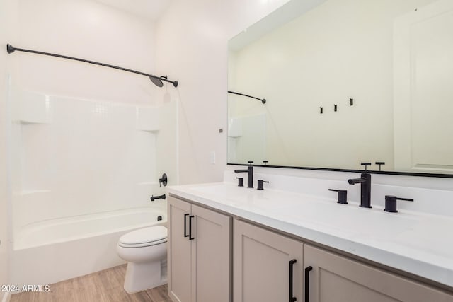 full bathroom with vanity, toilet, hardwood / wood-style floors, and bathtub / shower combination