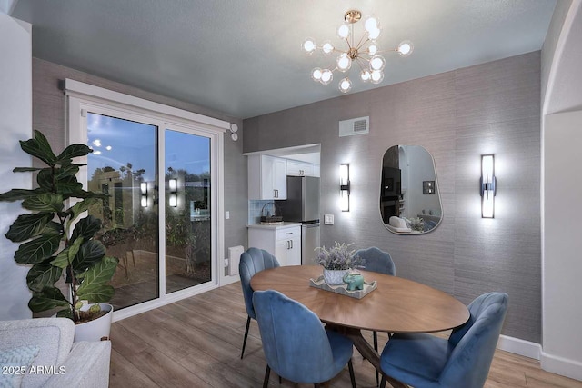 7596 N Via De La Siesta, Scottsdale, AZ 85258 - dining space featuring light wood-style flooring, baseboards, and a chandelier