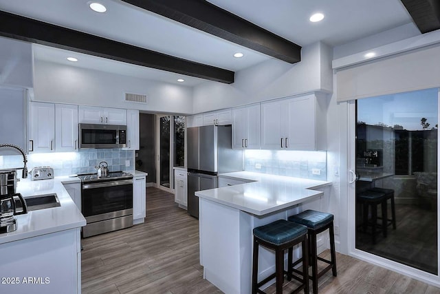 7596 N Via De La Siesta, Scottsdale, AZ 85258 - kitchen featuring stainless steel appliances, a sink, beam ceiling, tasteful backsplash, and white cabinetry