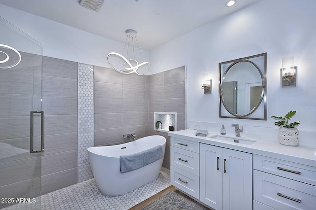 7596 N Via De La Siesta, Scottsdale, AZ 85258 - bathroom with a chandelier, vanity, a freestanding tub, and tile patterned floors