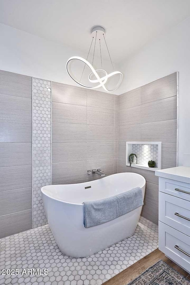 7596 N Via De La Siesta, Scottsdale, AZ 85258 - bathroom with tile walls, a soaking tub, and a chandelier
