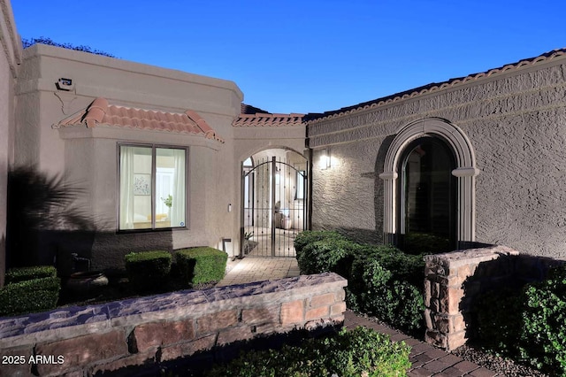 7596 N Via De La Siesta, Scottsdale, AZ 85258 - property entrance featuring stucco siding, a tile roof, and a gate