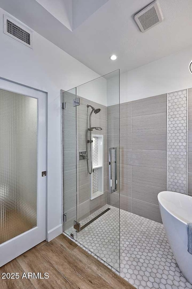 7596 N Via De La Siesta, Scottsdale, AZ 85258 - full bath with a shower stall, wood finished floors, a soaking tub, and recessed lighting