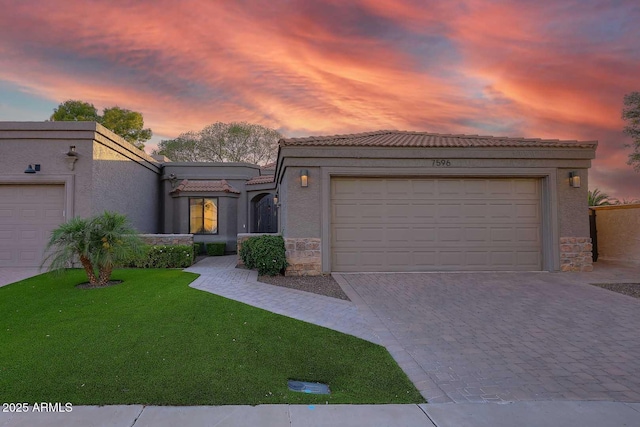 7596 N Via De La Siesta, Scottsdale, AZ 85258 - view of front of property featuring a tile roof, stone siding, stucco siding, and decorative driveway