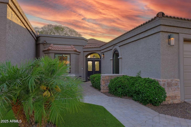 7596 N Via De La Siesta, Scottsdale, AZ 85258 - entrance to property featuring french doors, stucco siding, a tile roof, and stone siding