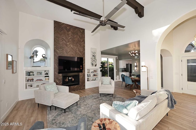7596 N Via De La Siesta, Scottsdale, AZ 85258 - living area featuring high vaulted ceiling, arched walkways, beam ceiling, wood finished floors, and a ceiling fan