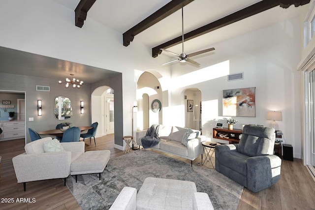 7596 N Via De La Siesta, Scottsdale, AZ 85258 - living room with arched walkways, ceiling fan, a high ceiling, wood finished floors, and beam ceiling
