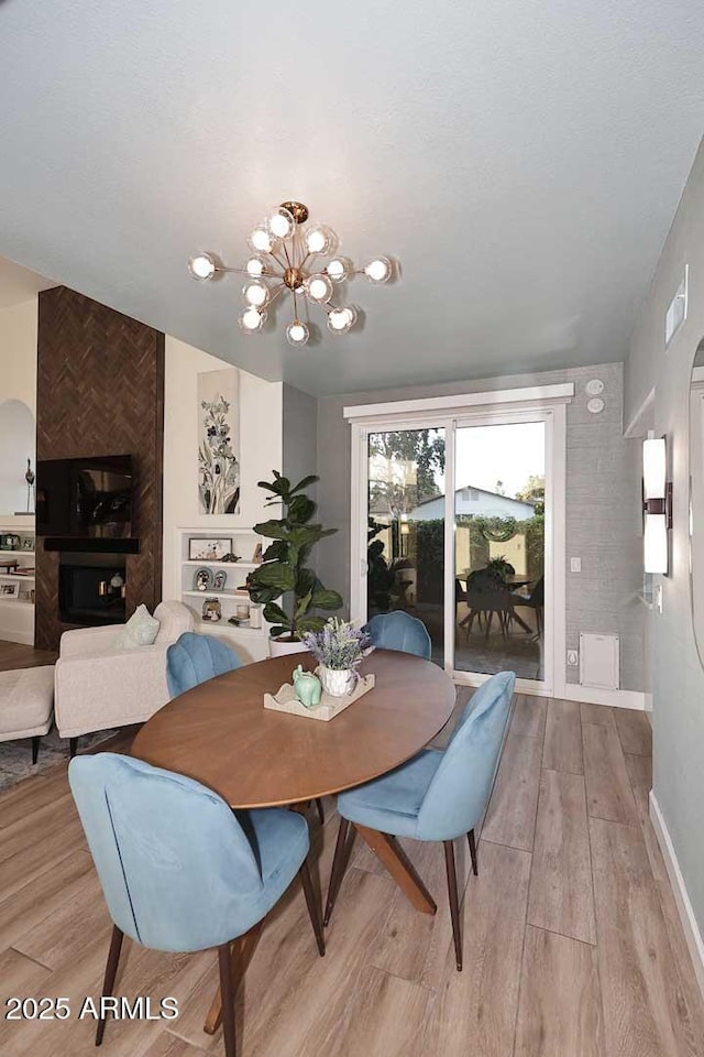 7596 N Via De La Siesta, Scottsdale, AZ 85258 - dining area with light wood-type flooring, a chandelier, and baseboards