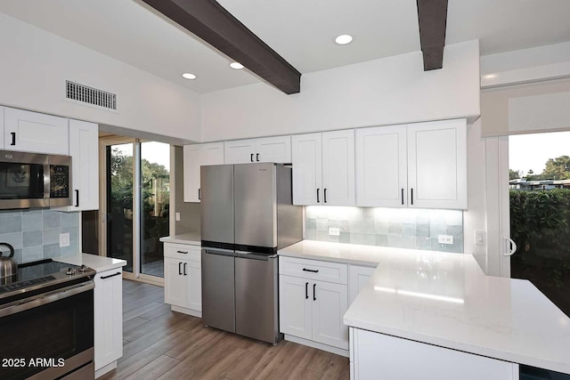 7596 N Via De La Siesta, Scottsdale, AZ 85258 - kitchen featuring appliances with stainless steel finishes, plenty of natural light, beamed ceiling, light countertops, and tasteful backsplash