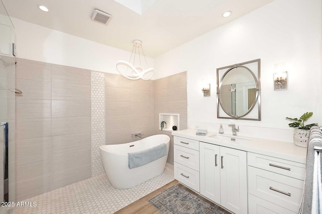 7596 N Via De La Siesta, Scottsdale, AZ 85258 - bathroom featuring vanity, a freestanding tub, a chandelier, and a tile shower