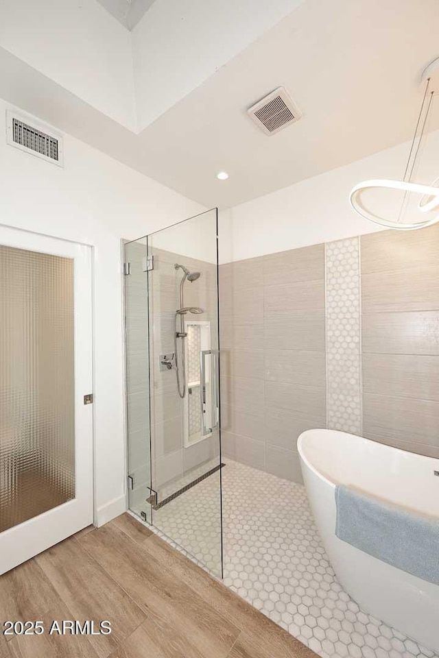 7596 N Via De La Siesta, Scottsdale, AZ 85258 - bathroom with a shower stall, wood finished floors, and a freestanding bath