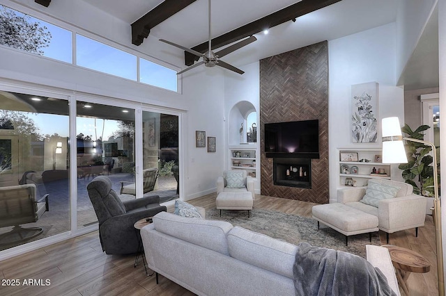 7596 N Via De La Siesta, Scottsdale, AZ 85258 - living room with a high ceiling, wood finished floors, ceiling fan, baseboards, and beamed ceiling