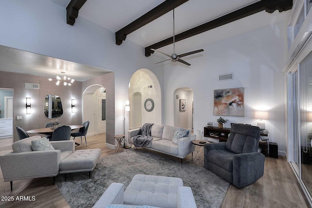 7596 N Via De La Siesta, Scottsdale, AZ 85258 - living room with arched walkways, wood finished floors, a high ceiling, a ceiling fan, and beam ceiling