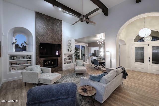 7596 N Via De La Siesta, Scottsdale, AZ 85258 - living room with a chandelier, high vaulted ceiling, built in features, arched walkways, and a ceiling fan