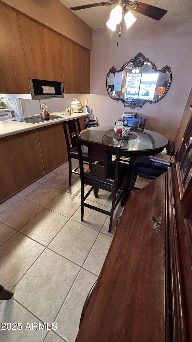 1440 N Idaho Rd Unit 1022, Apache Junction, AZ 85119 - dining room featuring light tile patterned floors, ceiling fan, and a textured ceiling
