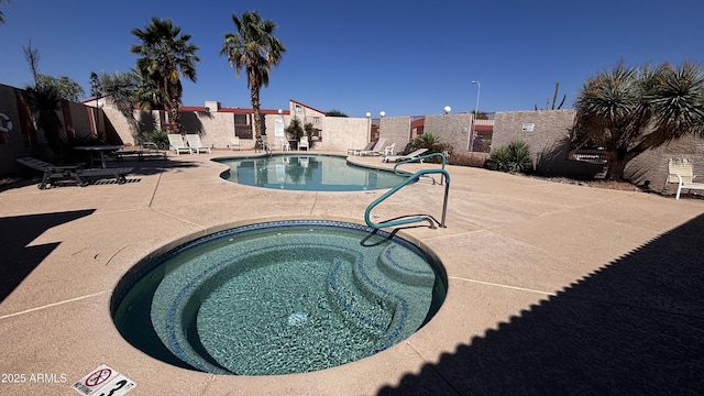 1440 N Idaho Rd Unit 1022, Apache Junction, AZ 85119 - community pool featuring a hot tub and a patio area