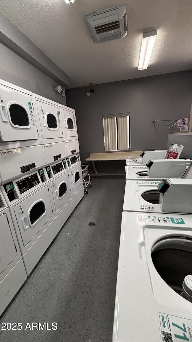 1440 N Idaho Rd Unit 1022, Apache Junction, AZ 85119 - shared laundry room featuring stacked washer and clothes dryer, washer and clothes dryer, and a textured ceiling