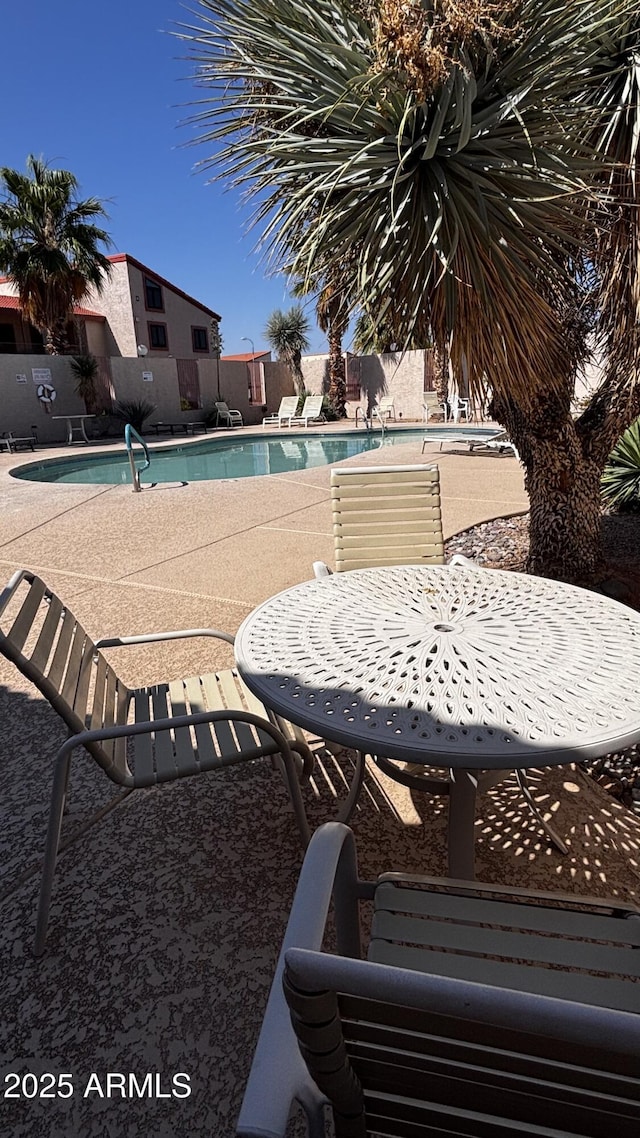 1440 N Idaho Rd Unit 1022, Apache Junction, AZ 85119 - community pool featuring a patio