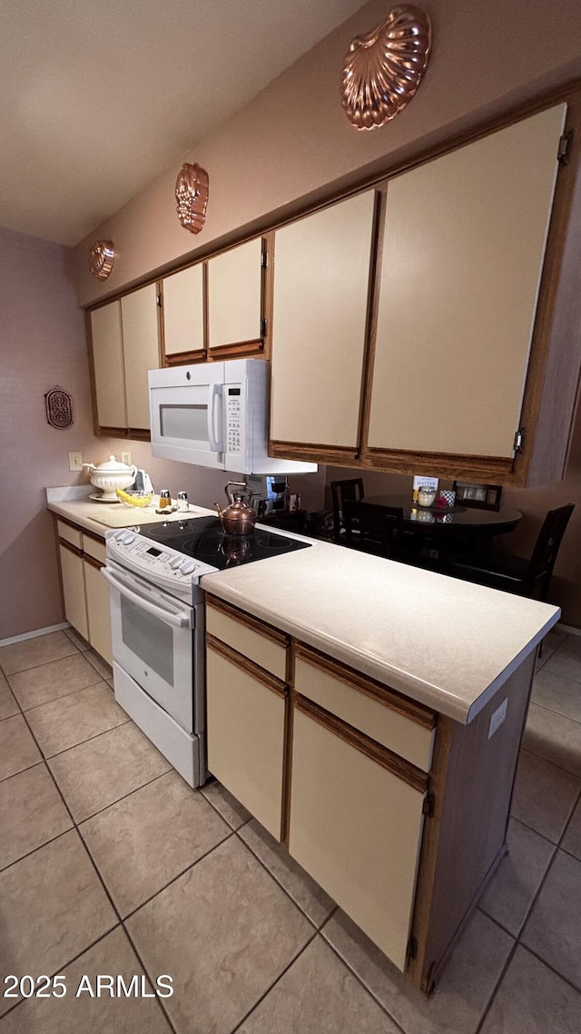 1440 N Idaho Rd Unit 1022, Apache Junction, AZ 85119 - kitchen with white microwave, electric stove, and light countertops