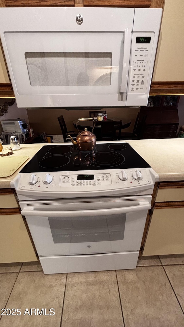 1440 N Idaho Rd Unit 1022, Apache Junction, AZ 85119 - kitchen featuring white appliances, light tile patterned flooring, and light countertops