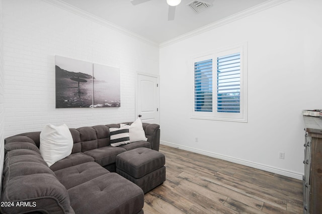 living area featuring visible vents, ornamental molding, ceiling fan, wood finished floors, and baseboards