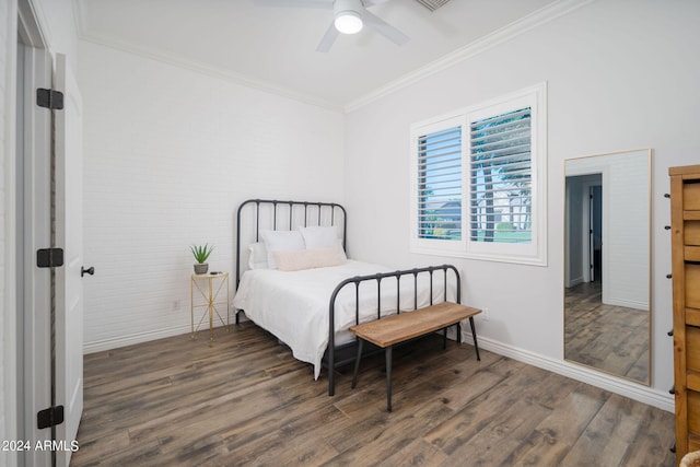 bedroom featuring baseboards, ceiling fan, wood finished floors, and crown molding