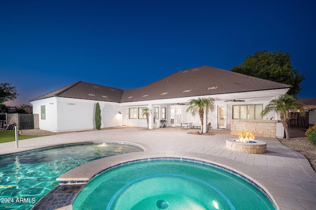 view of pool with a fire pit, an in ground hot tub, fence, a fenced in pool, and a patio area