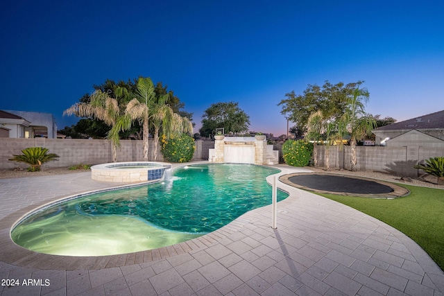 view of pool featuring a fenced backyard, a pool with connected hot tub, and a patio