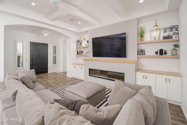 living room featuring recessed lighting, dark wood-type flooring, coffered ceiling, beamed ceiling, and a glass covered fireplace