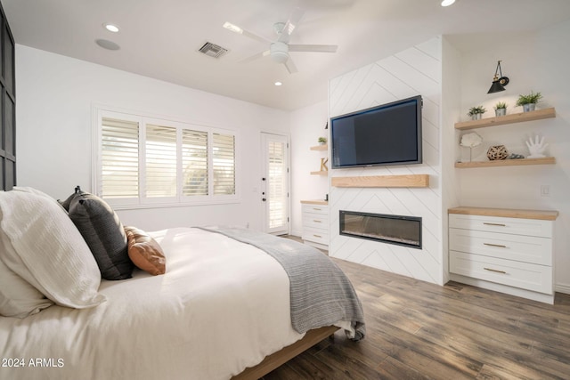 bedroom featuring a large fireplace, visible vents, a ceiling fan, wood finished floors, and recessed lighting