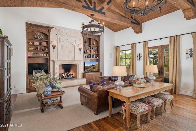 living room with high vaulted ceiling, a high end fireplace, hardwood / wood-style flooring, built in shelves, and wood ceiling