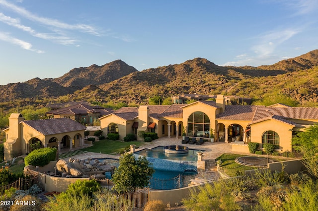 view of pool featuring a mountain view, a hot tub, and a patio area