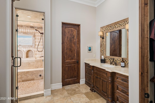 bathroom with crown molding, vanity, and a shower with shower door