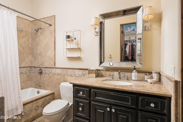 full bathroom featuring shower / tub combo, vanity, toilet, and tile walls