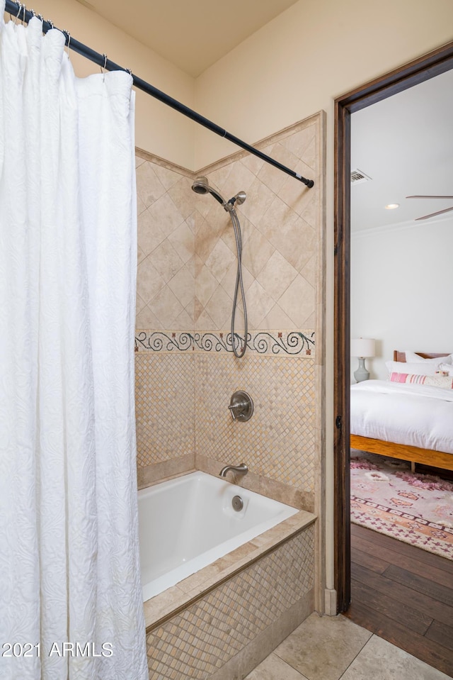 bathroom with tile patterned flooring and shower / bath combination with curtain