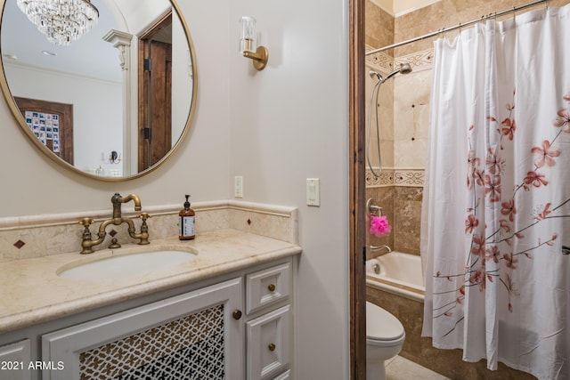 full bathroom with a chandelier, vanity, shower / bath combination with curtain, and toilet