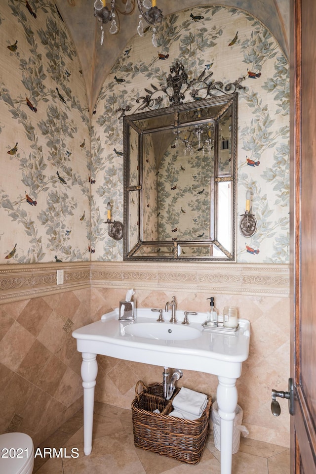 bathroom with toilet and lofted ceiling