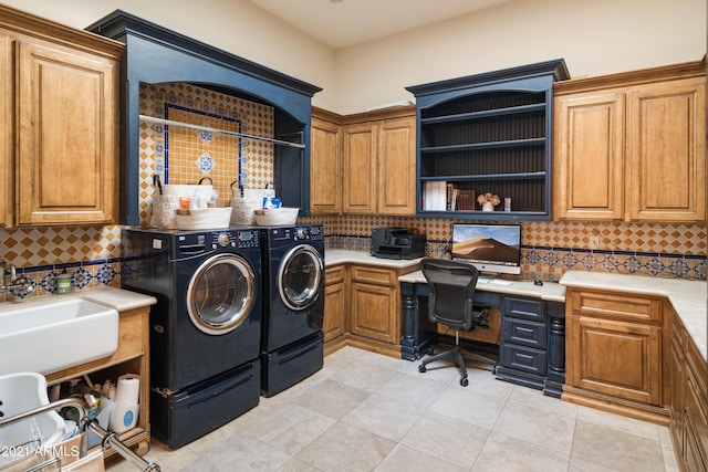 laundry room with cabinets, sink, light tile patterned floors, and washer and dryer