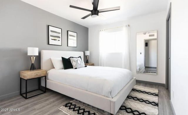 bedroom with hardwood / wood-style floors and ceiling fan