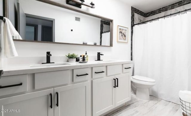 bathroom with vanity, a shower with curtain, and toilet