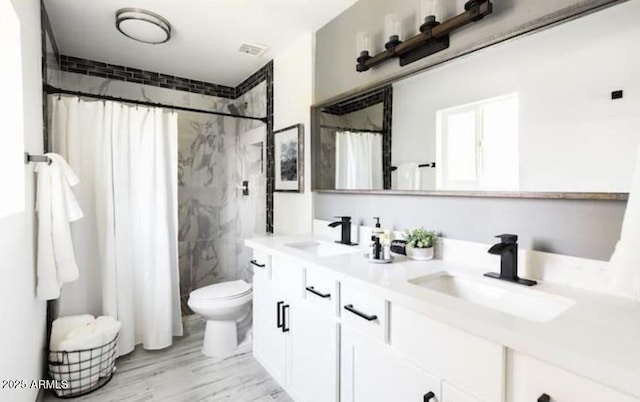 bathroom with a shower with curtain, vanity, hardwood / wood-style floors, and toilet