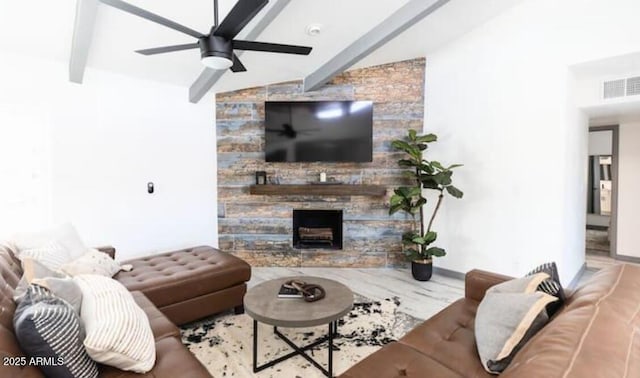 living room featuring vaulted ceiling with beams, a fireplace, and ceiling fan