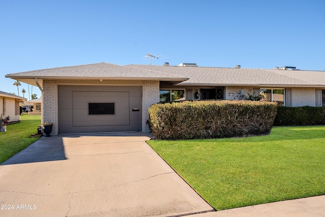 ranch-style home with a front yard and a garage