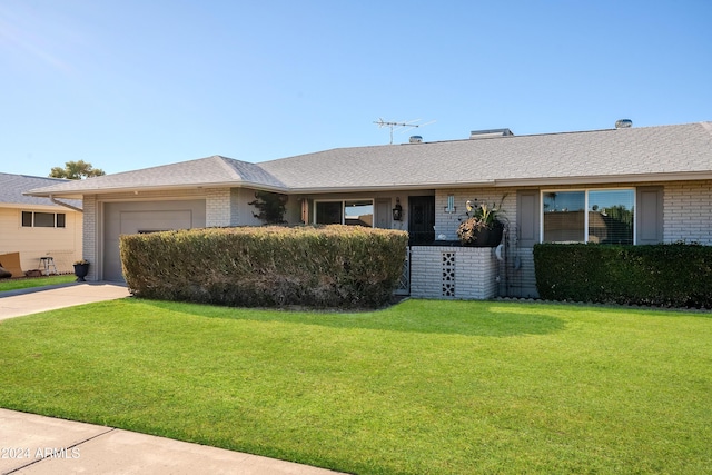 single story home featuring a front lawn and a garage