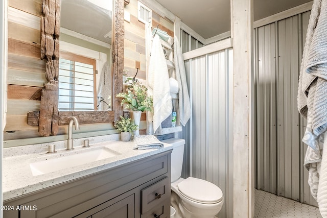 bathroom featuring crown molding, tile patterned flooring, vanity, and toilet