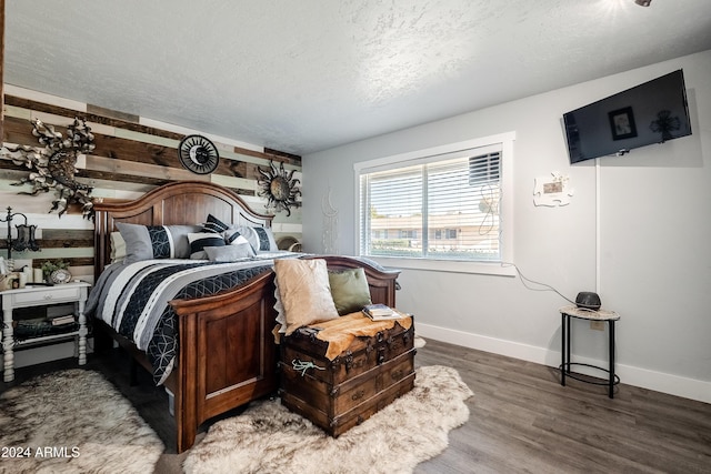 bedroom featuring wood-type flooring and a textured ceiling