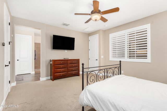 bedroom with ceiling fan and light carpet