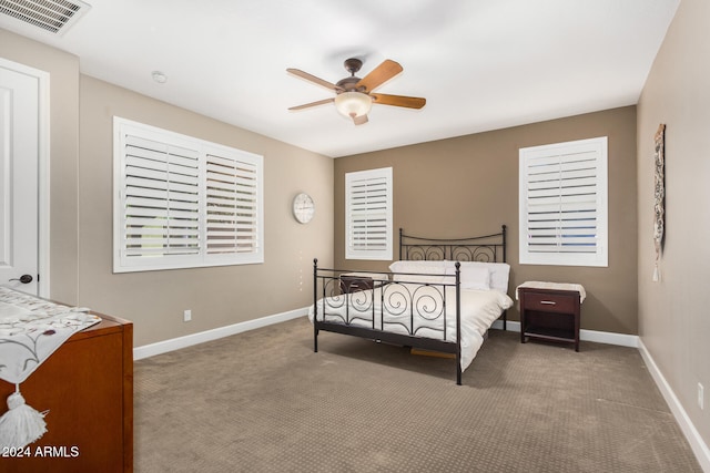 bedroom featuring light carpet and ceiling fan