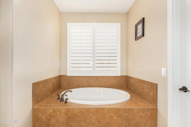 bathroom with a relaxing tiled tub